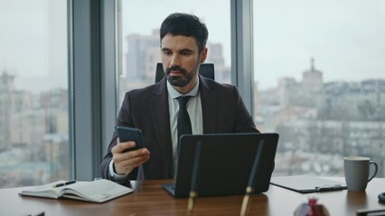 Boss answering phone call sitting modern office close up. Man dissatisfied talk