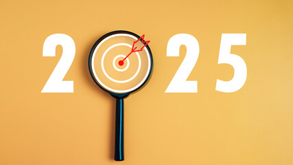 Dartboard icon in a magnifying glass centered on the number 2025 on a yellow background. Represents the goal setting for 2025, concept of a start. financial planning, strategy business, goal setting. - obrazy, fototapety, plakaty