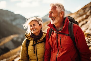 Senior couple admiring the scenic Pacific coast while hiking, filled with wonder at the beauty of nature during their active retirement. Exploring the great outdoors in the mountains, active lifestyle