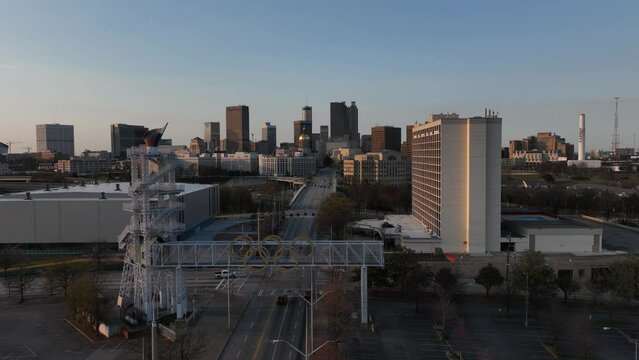 Aerial timelapse of traffic movement across Atlanta Olympic Cauldron Tower street with the view of iconic skyscrapers and government buildings in the background
