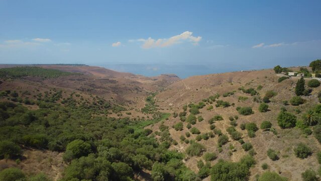 Ein Peak - spring in the south of the Golan Heights area and a remains of Syrian village, close to Kibbutz Afik - Sea of Galilee in the background (yam kinneret)