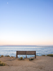 Fototapeta na wymiar Bench at Sunset by the Pacific Ocean in Pleasure Point, California, Santa Cruz Monterey Bay