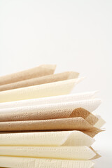Beige paper napkins on white background studio shot