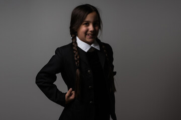 Halloween. A girl in a suit. Holiday. Hallowmas. Wednesday Addams. The Addams Family. Reincarnation. Cosplay. Idea for Halloween. Portrait of a girl.