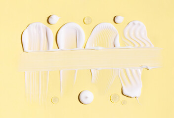 cosmetic smears of creamy texture on a pastel background