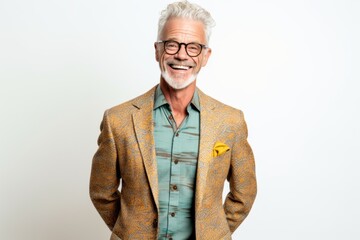 Portrait of a senior man with grey hair in a yellow jacket on a white background.