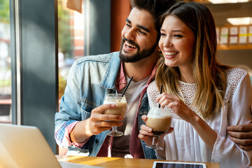 Romantic couple in cafe is drinking coffee and enjoying being together