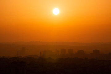 Istanbul cityscape with the reflection of the yellow color of the sunset on the skyscrapers.