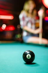 8 Ball from pool or billiards on a billiard table. People entertainment game concept