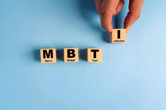 Wooden blocks with the letters MBTI on blue background. Personality typology. Psychology test for human types.MBTI - Myers-Briggs Type Indicator.