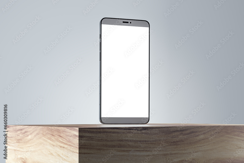 Poster close up of blank white smartphone screen on wooden surface and gray wall background. product presen