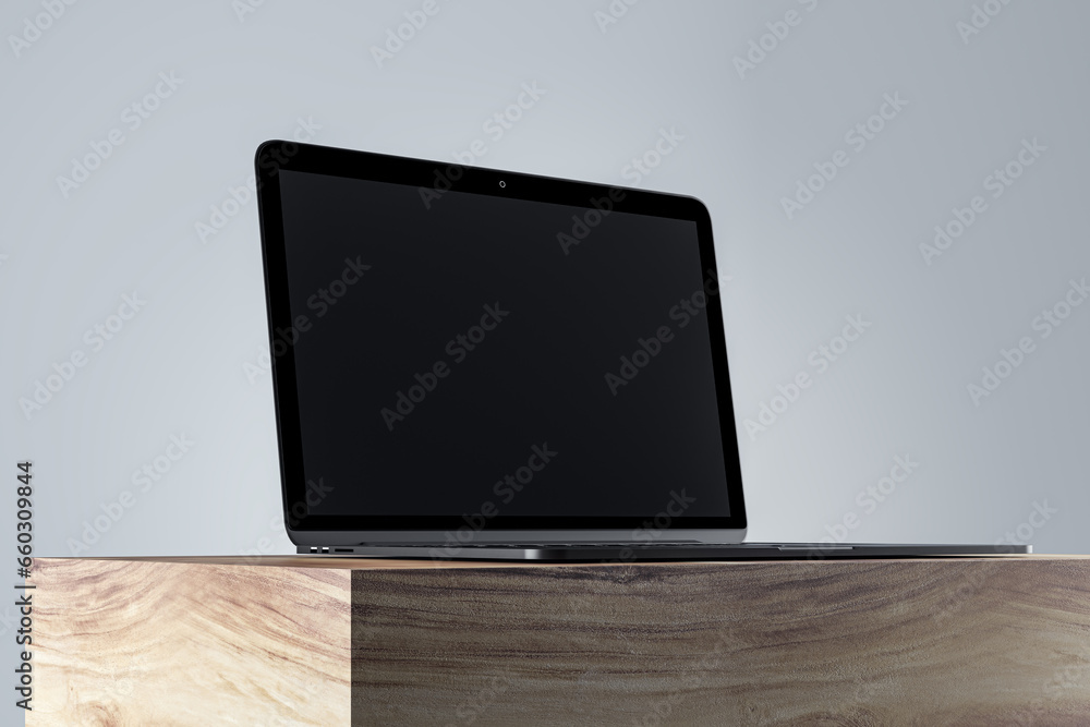 Poster Close up of empty laptop monitor on wooden surface and gray wall background. Product presentation and advertisement concept. Mock up, 3D Rendering.