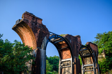 Red Brick arches at both ends are combined with a central steel truss. Longteng Broken Bridge is a historic roadside attraction in the rolling hills.