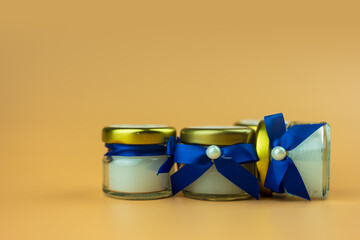 Aroma scented candle for gift for the guests at the wedding ceremony wrapped with bow blue.