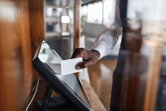 Close up of server using computer in restaurant and swiping card putting orders in POS system, copy space