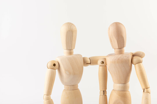 Wooden people hugging. People relationship concept. Friends.