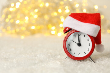 A clock with a Santa hat with a New Year's decoration.
