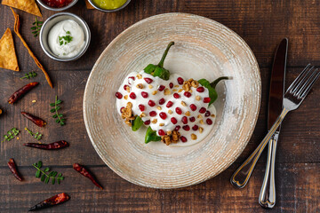 Chiles en Nogada, a traditional Mexican dish made with pablano chili stuffed with meat and fruit and garnished with pomegranate seeds and walnuts