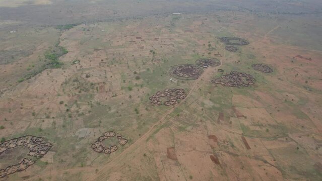 Traditional tribal village of Ugandan tribes in African savannah of Karamoja region. Uganda in Africa. Aerial drone view