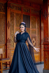 Obraz premium Women's fashion model. Female makeup model. Asian woman. Indonesian women. wearing a black wedding dress. Black wedding dress.