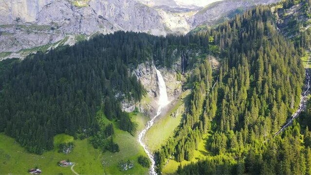 panoramic aerial view of idyllic Swiss Alpine waterfall in the Alps of Switzerland featuring Glacier-fed St&auml;ubifall and village of &Auml;sch near Klausenpass in the Canton of Uri 
