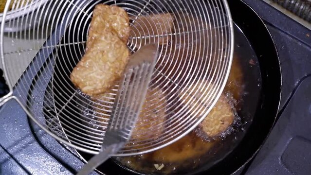 the process of cooking tempeh at home, Indonesia's favorite traditional dish derived from soybeans. Indonesian street food.