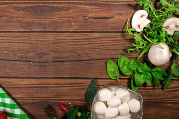 Background for Pizza with tomatoes, mozzarella cheese, black olives and basil. Mock up for Delicious italian pizza on wooden table. Table top view