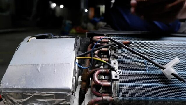 Air Conditioning that is being disassembled or serviced by a home repairman. 