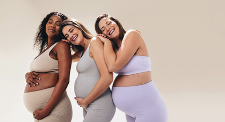 Pregnant mothers bonding and supporting each other in a fitness class