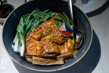 Kare-kare is a Philippine stew that features a thick savory peanut sauce.
