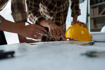 Engineers, designers and interior designers are finalizing the design of interiors by discussing selecting materials and colors to design rooms to present to clients.