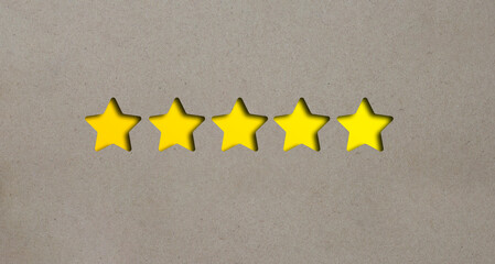 Cut out 5 stars from brown paper on a yellow background.