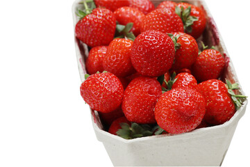 Freshly harvested ripe garden strawberries in recycled paper food container on a white background, top view close-up. Copy space.  Isolated on Transparent background. PNG file. Clipping path