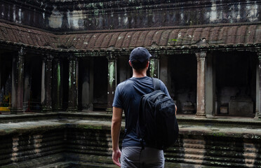 Unrecognizable European Tourist In Angkor Wat temple ruins