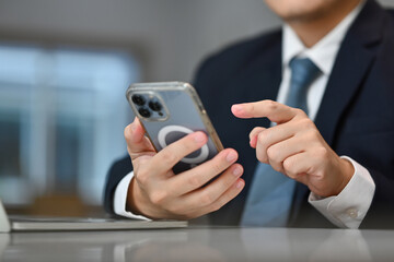 Young businessman texting message on smartphone. Communication, technology and business lifestyle concept