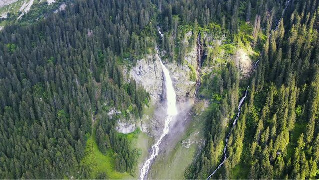 panoramic aerial view of idyllic Swiss Alpine waterfall in the Alps of Switzerland featuring Glacier-fed St&auml;ubifall and Alps of &Auml;sch near Klausenpass in the Canton of Uri 
