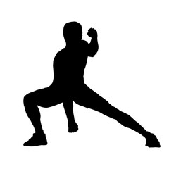 Silhouette of a sporty male in action pose at the gym. Silhouette of a slim man in aerobics workout pose.