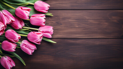 Fresh Pink Tulips on dark wooden background top down