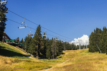 Chairlift on mountain landscape at summer day.