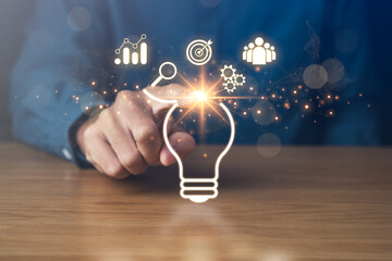 Business goal Success and Creative Solutions.Inspired Work,Brainstorming,Achieving Success and Creative Ideas concept.businessman pointing light bulb.