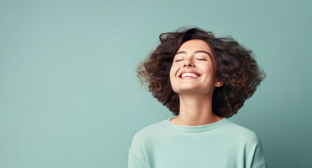 Great pleasure, Woman eyes closed and smile at the corner of the mouth on mint background