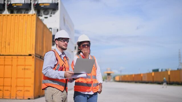 Engineers railway team wearing safety uniform under conversation document on hand inspection survey container boxes railway work station is industry transportation cargo import export concept.