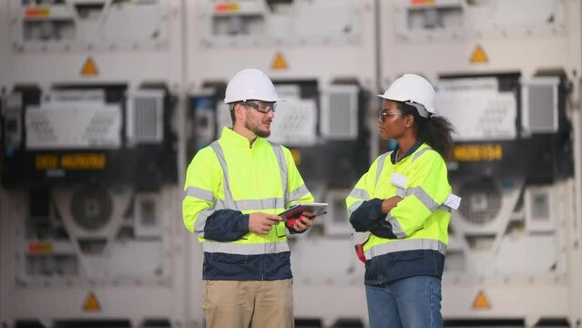 Engineers railway team wearing safety uniform under conversation document on hand inspection survey container boxes railway work station is industry transportation cargo import export concept.