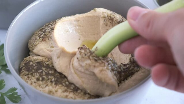 Traditional hummus with oil, spices and cucumber.