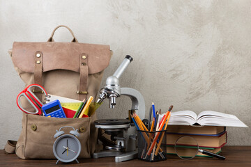Back to school - books and school backpack on the desk in the auditorium, Education concept.