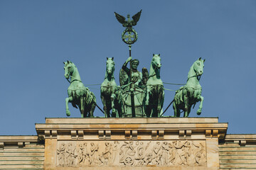 Fototapeta na wymiar view of majestic historical gate in city with copper statues of horses and woman riding carriage branderburg 