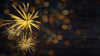 HAPPY NEW YEAR - Sylvester, New Year's Eve 2024 Party, New year, Firework celebration background banner - Golden fireworks and bokeh lights on dark rustic wooden wall texture in the night.
