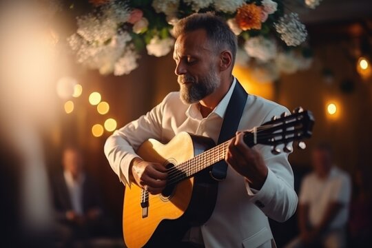 A picture of a man dressed in a white suit playing a guitar. This image can be used to depict musicians, live performances, concerts, or music-related events