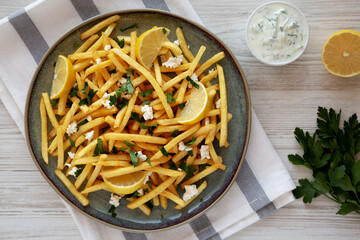 Homemade Greek Fries with Feta and Tzatziki on a Plate, top view. Flat lay, overhead, from above.