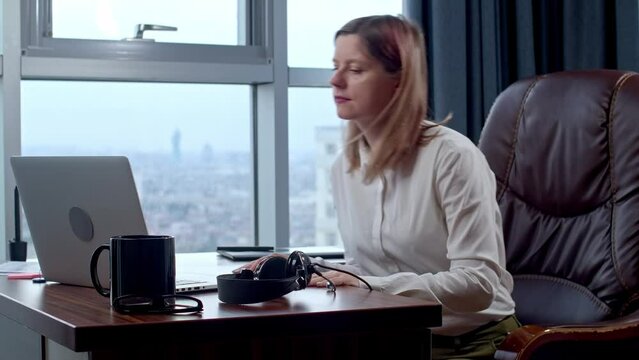 Woman starting day in a home office, remote workplace, call center operator came on a shift. The developer preparing for a phone call, project manager started a conference call.